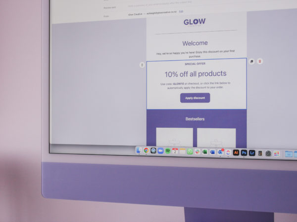 Purple Mac computer with Shopify email campaign being set up on the screen